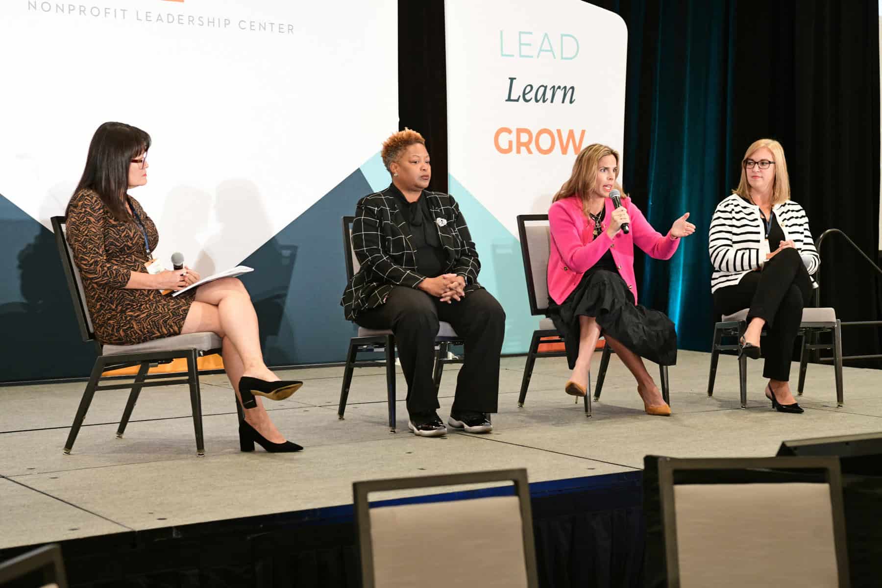 A group of diverse women speaking on stage at the Nonprofit Leadership Conference