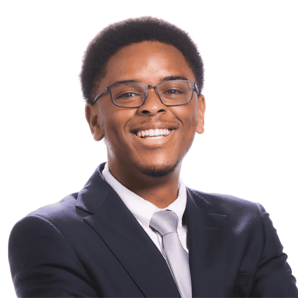 Headshot of Albert Rejouis, a young Black man with glasses wearing a black suit jacket, white shirt and silver tie.