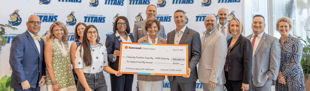 A diverse group of leaders accepting a check for Community Foundation of Tampa Bay