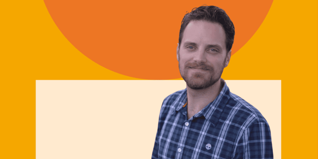 Photo of Chris Barlow, a white man with brown hair wearing a plaid button-down shirt behind an orange and peach background