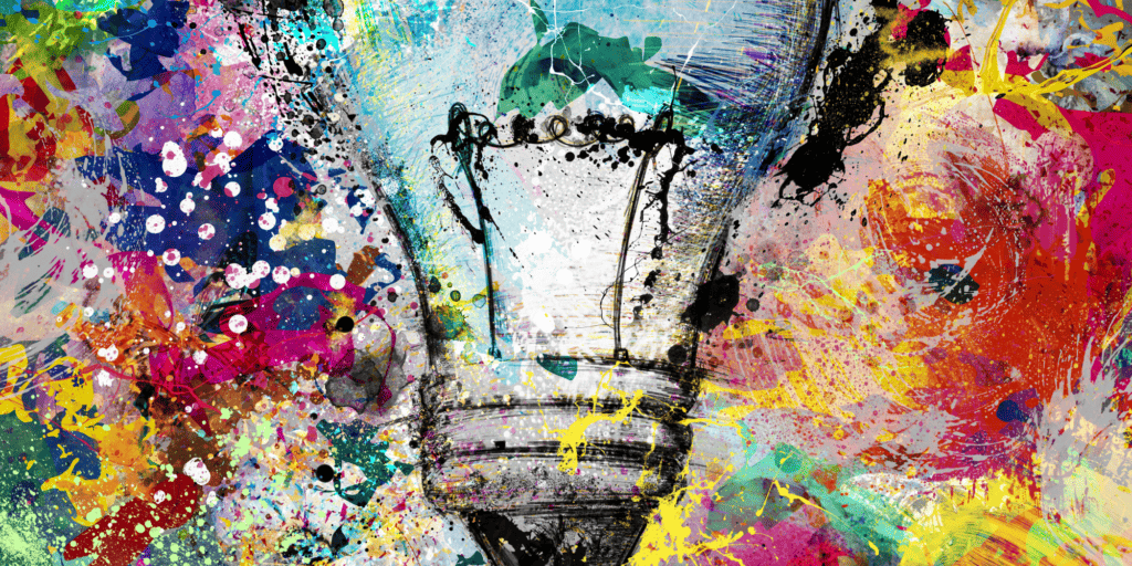 Graffiti art image of a light bulb surrounded by many colors of splattered paint