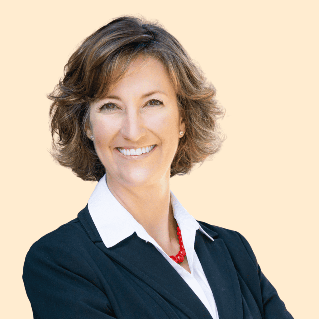 Photo of Jennifer Currence, a white woman wearing a navy suit jacket and smiling into the camera