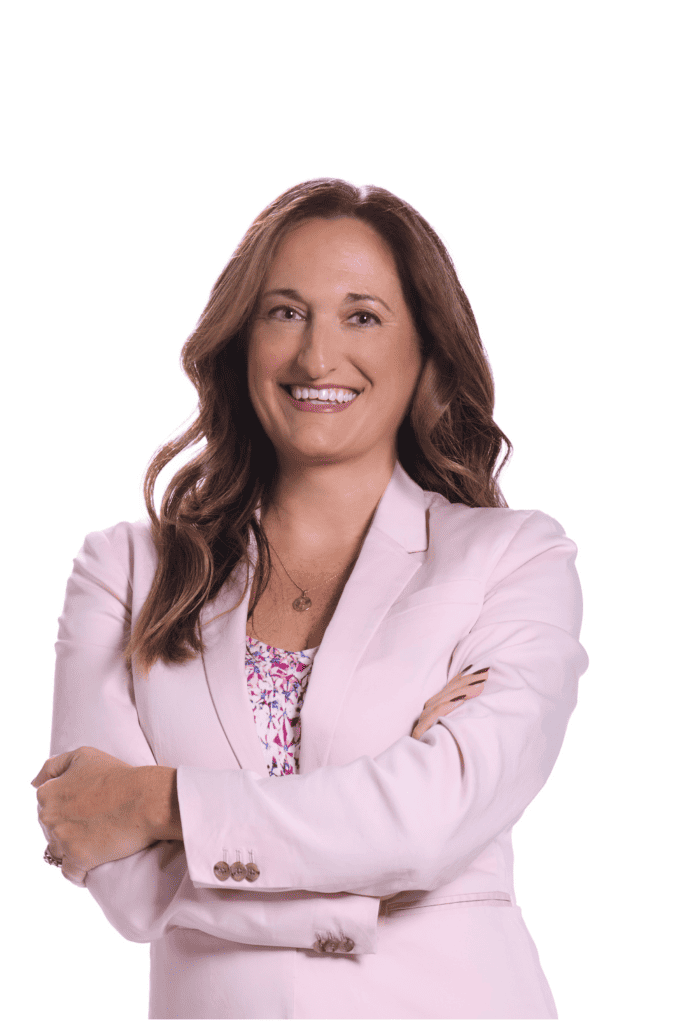 A white woman with long brown hair wearing a pink jacket