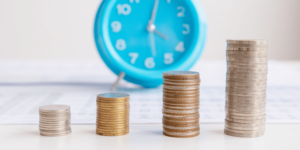 Stacks of coins in front of a blue clock: How to calculate the value of volunteer time