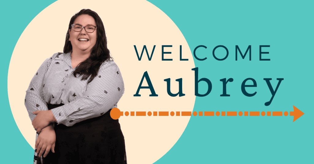 Photo of Aubrey Sampson, a white woman with long brown hair wearing a striped button down and black skirt next to the words: Welcome Aubrey