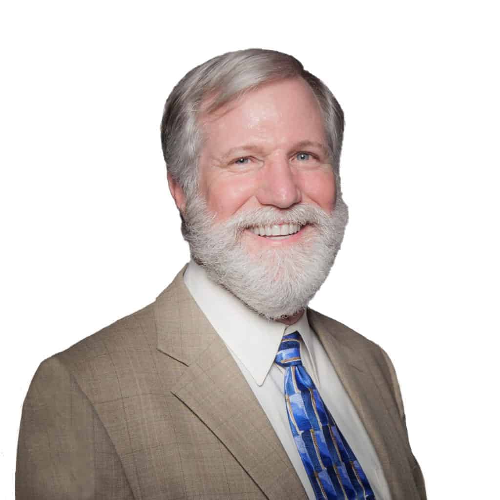 Headshot of Mark McCatty, a white man with grey hair and a grey mustache and beard wearing a tan suit jacket and blue tie