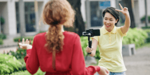Two women taking a video with a mobile device